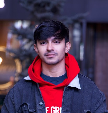 Aziz photo in red hoodie